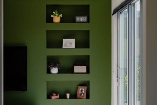 Built in shelving beside sliding doors in a modern living area, showcasing interior craftsmanship, natural light, and residential build quality.