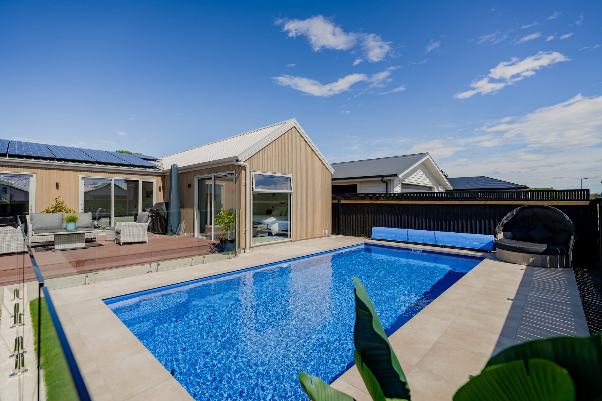Backyard pool and outdoor living area in a bespoke new build home, demonstrating high quality residential construction and outdoor space integration.
