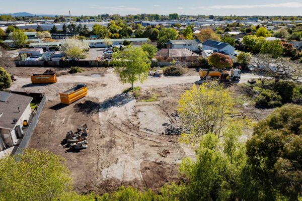 Construction machinery and site preparation for home construction and commercial construction work, supporting new houses and architectural homes within a larger construction and management project development.