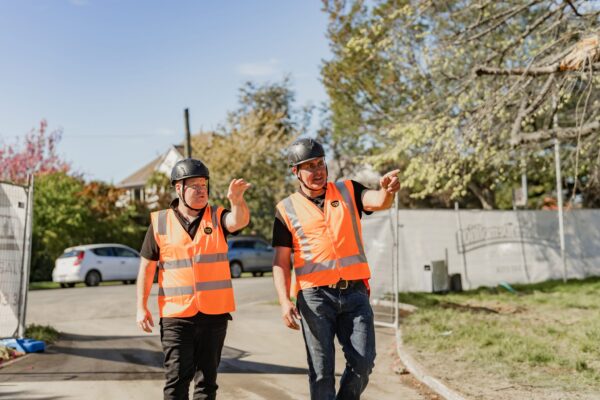 Two managers inspecting a construction site for new builds and new housing developments, highlighting construction management, building construction planning, architectural build processes and Design and build services for modern house projects.