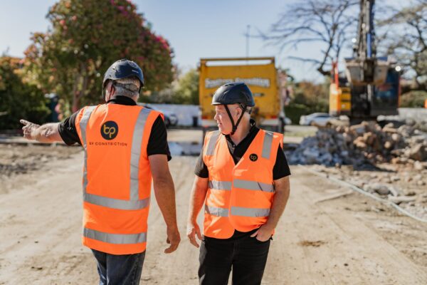 Construction supervisors discussing progress on a development site for new home developments and new build houses, showcasing construction NZ expertise, project construction, building inspection report processes and commercial refurbishment support.