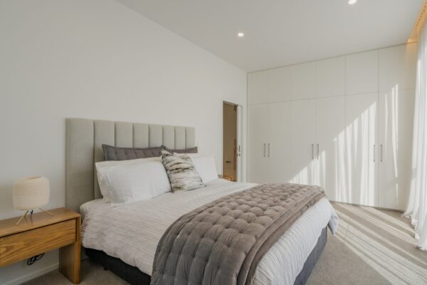Contemporary bedroom with built in wardrobes in a new build home, highlighting bespoke interior finishes and quality residential construction.
