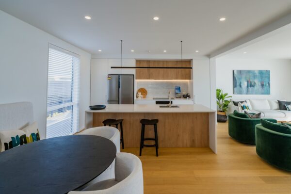 Open plan kitchen and dining area in a modern townhouse, showcasing design and build expertise, quality joinery, and residential construction craftsmanship.