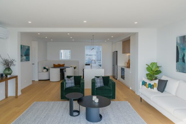 Open plan living, kitchen, and dining area in a modern house, part of a new build development managed by an experienced home builder and construction management team.