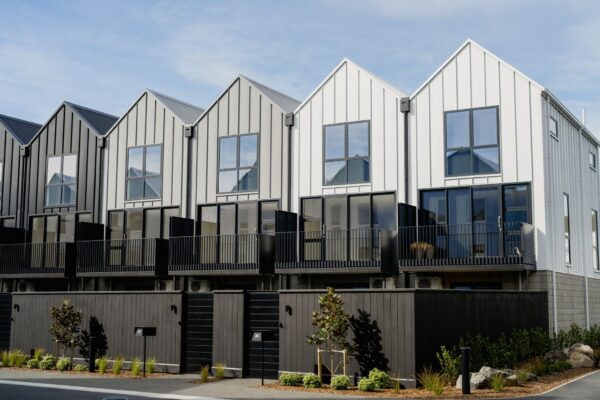 Row of architecturally designed townhouses forming a new build development, demonstrating quality building construction, architectural build expertise, and project construction management.