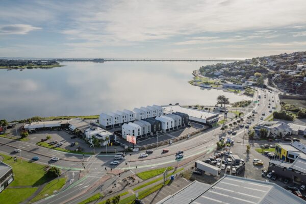 Aerial view of a waterfront townhouse development, highlighting large scale residential construction, architectural design, and new build housing in Christchurch.