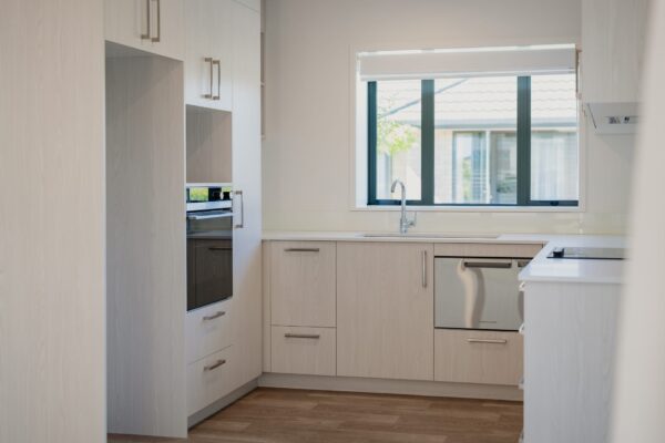 A newly renovated kitchen with bespoke finishes and modern fittings, representing high-end home construction, construction management and Design and build expertise often used in aged care refurbishment and new house projects in construction NZ.