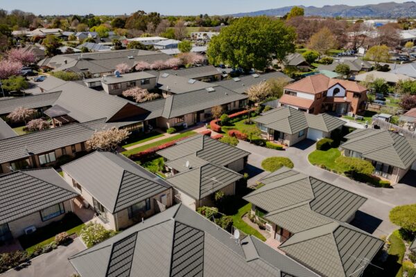 A broader aerial perspective of modern houses, architecturally designed homes and new build houses within an organised community, built through coordinated construction and management, project construction processes and Commercial Construction capability supporting long-term residential and aged care developments.