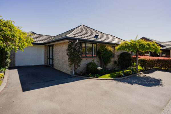 A tidy brick modern house exterior within a new housing development, reflecting architecturally designed homes delivered through construction NZ expertise, home builder companies and construction and management teams specialising in new build houses, property inspection report standards and long-term aged care construction.