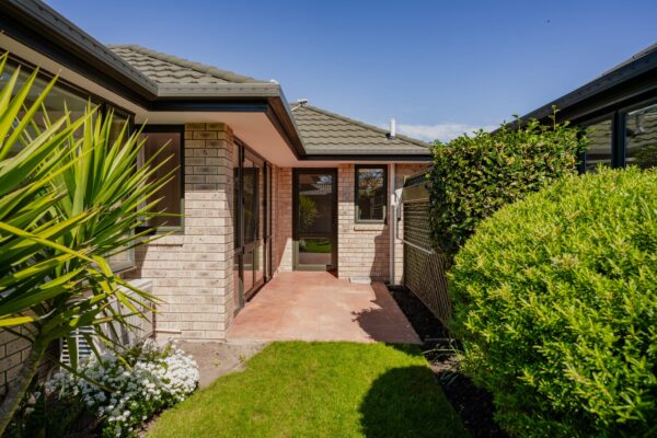 A landscaped courtyard beside a modern house after refurbishment, showcasing bespoke renovations, new build houses, architectural homes and home repair insurance projects supported by construction NZ expertise and homebuilder companies.