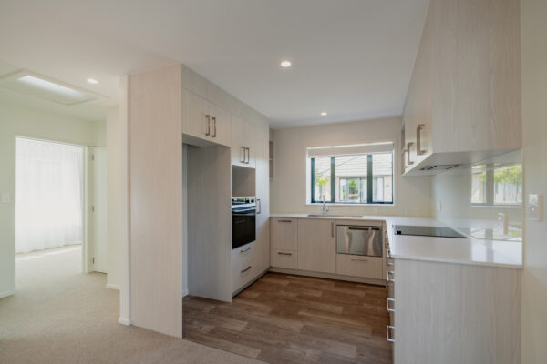 A modern kitchen in a newly refurbished care facility, showcasing bespoke renovations, architectural build quality, construction NZ craftsmanship, and Design and build services delivered by an experienced homebuilding company.