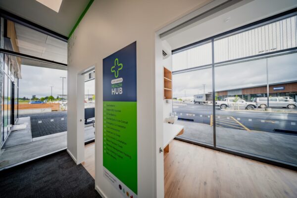 A consultation room and signage inside a newly completed pharmacy fit out, illustrating Commercial Construction, commercial fit out quality, refurbishment work and construction NZ standards in a modern health environment.