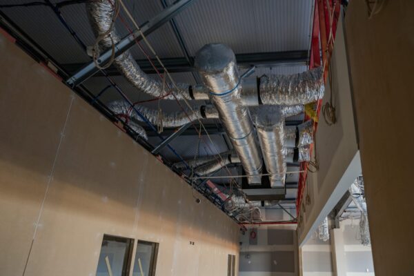 Exposed HVAC ducting and ceiling services inside a commercial fit out, demonstrating Commercial Construction expertise, construction NZ technical capability, architectural plans in action and detailed project construction management.